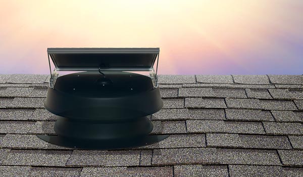 Natural Light solar attic fan on flat roof shot from behind with sunburst mobile