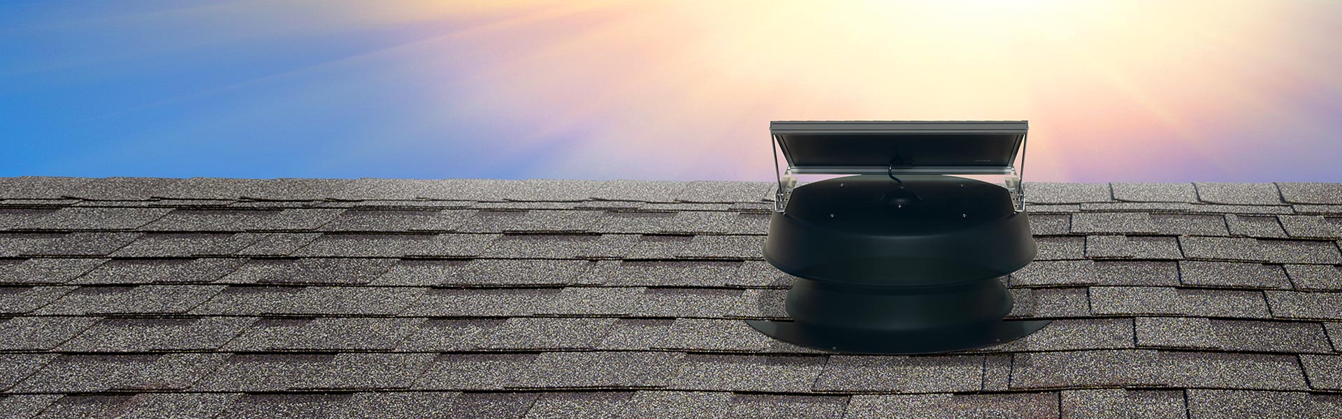 Natural Light solar attic fan on flat roof shot from behind with sunburst