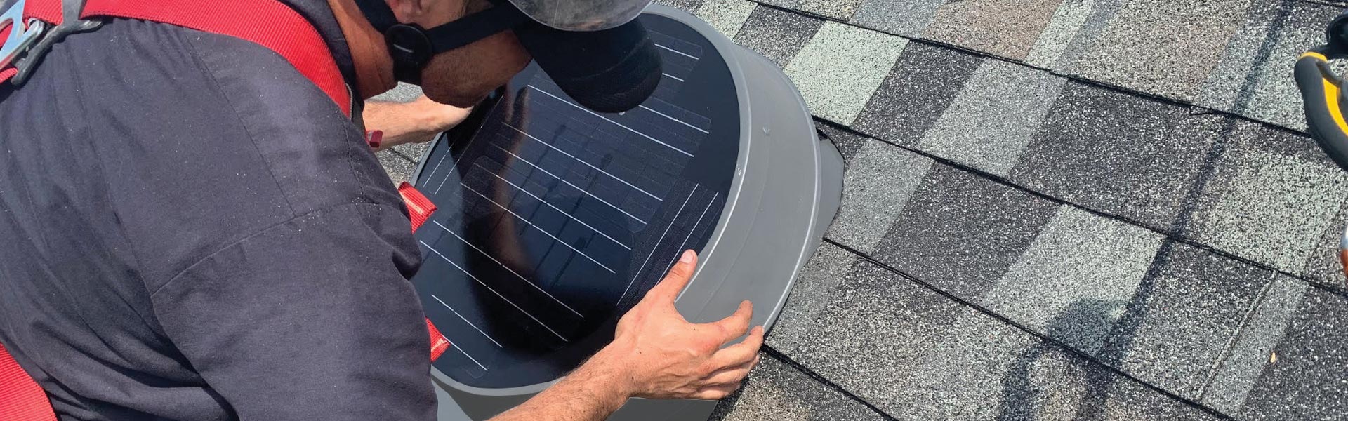 Natural Light installer on roof attaching solar attic fan