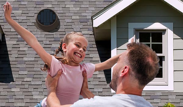 father and daughter in front of home with Natural Light solar attic fan installed Mobile